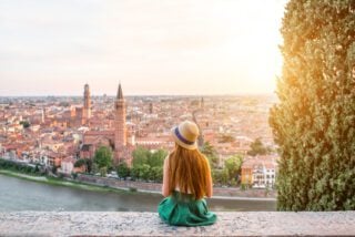 Woman enjoying beautiful view on Verona city while living abroad