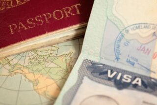 a close-up of an expat visa sitting next to a passport