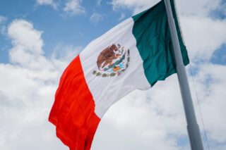 the Mexican flag waving in the wind