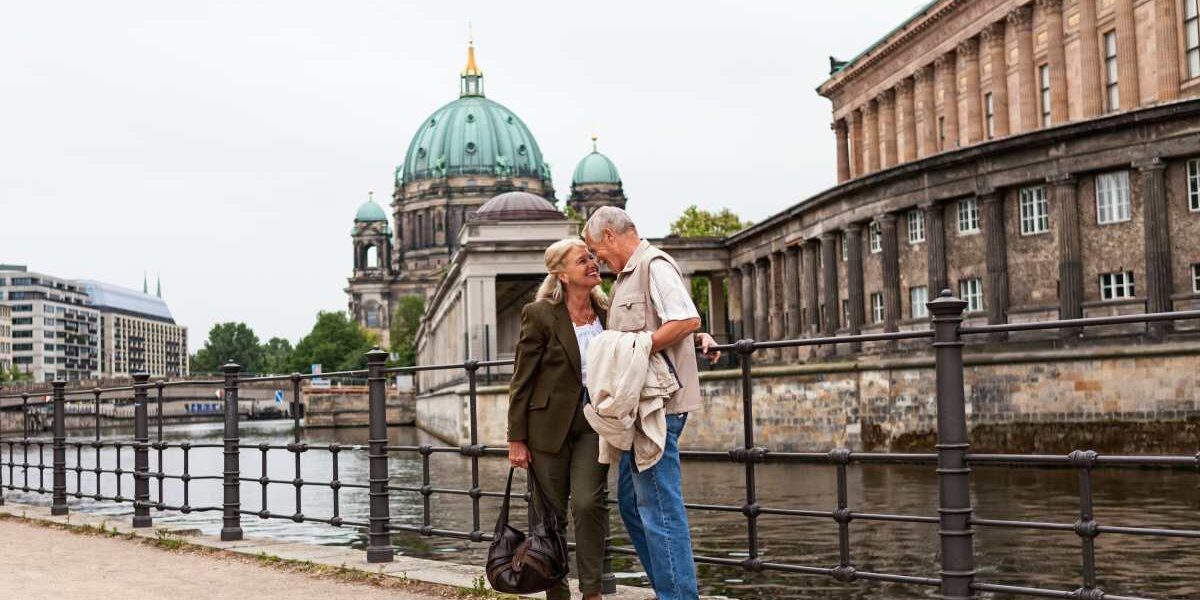 A happy senior couple standing by Berlin Cathedral in one of the best cities for retiring in Germany