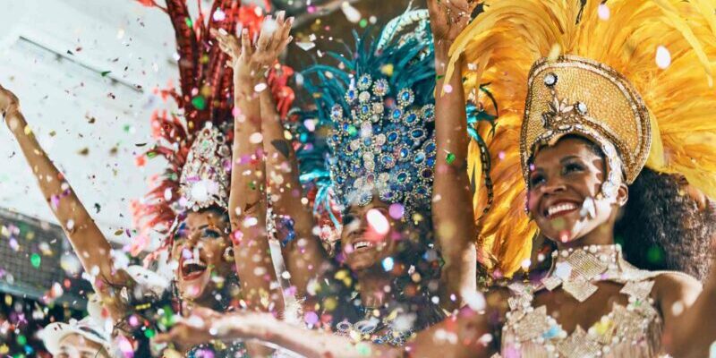 dancers dressed in vibrant costumes dancing in a Brazilian Carnival parade