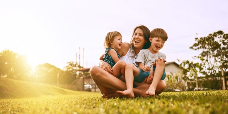 a mother and her two children enjoying time outside, after moving to Brazil