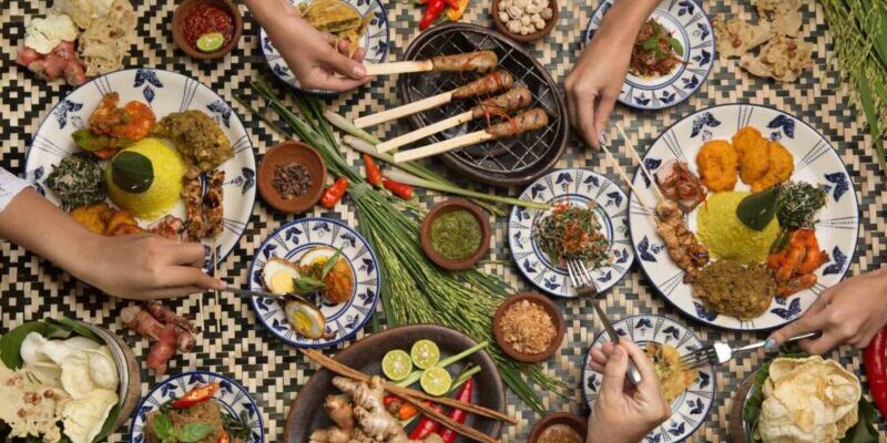 an aerial shot of friends enjoying Indonesian food