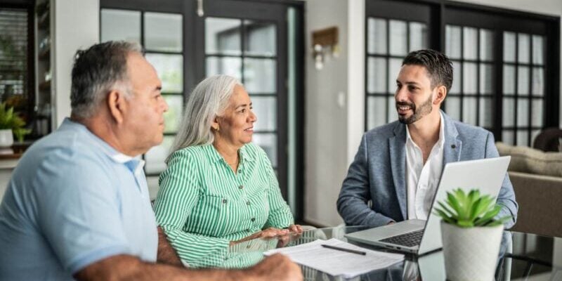 a senior couple meeting with an accountant to discuss their finances after retiring abroad