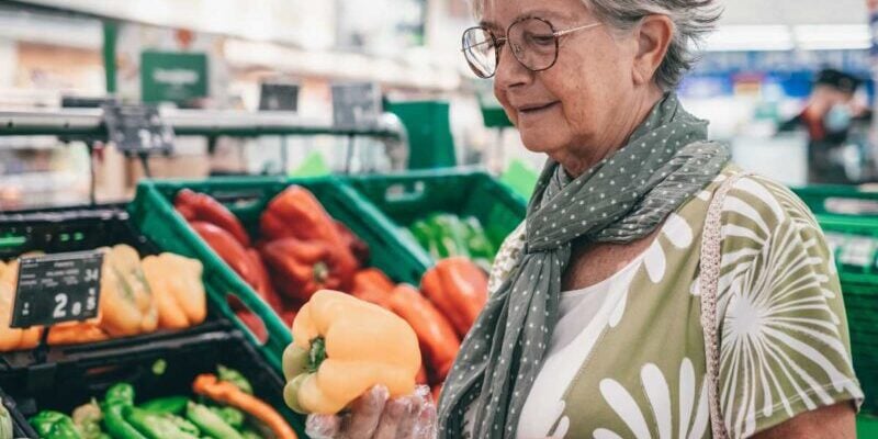 a retiree shopping for groceries in a supermarket after retiring abroad