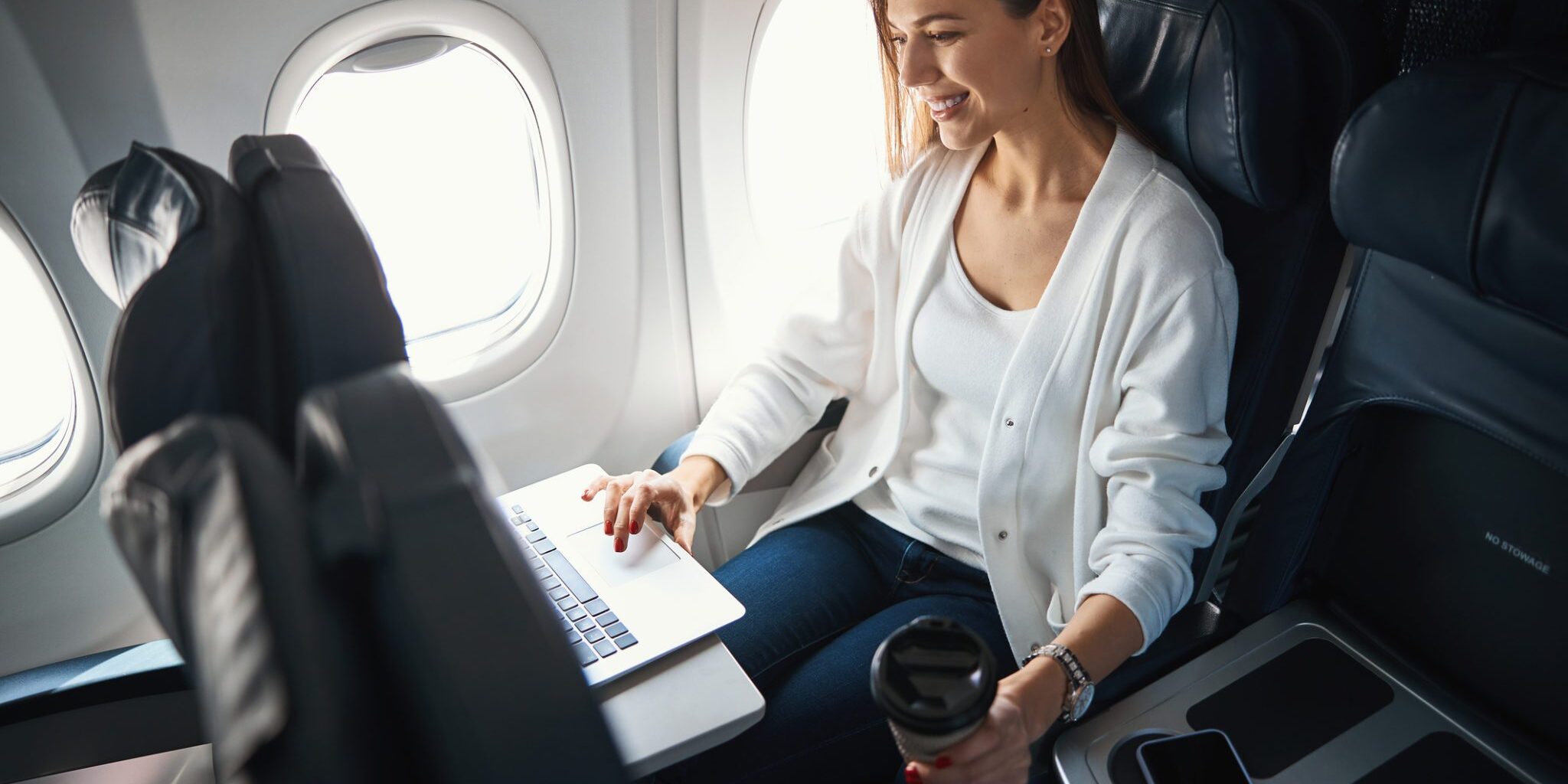 woman sitting in window seat on a plane